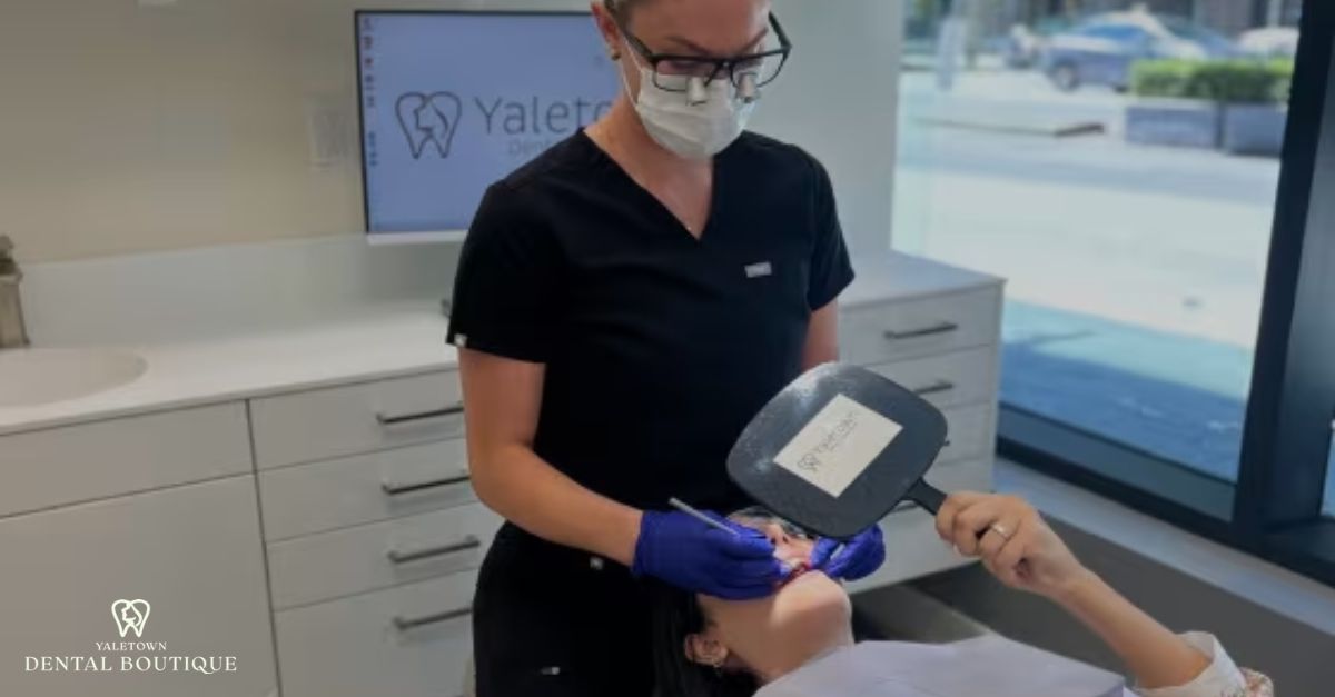 Dentist assisting a patient during the getting dental bridge process in Yaletown Dental Boutique clinic.