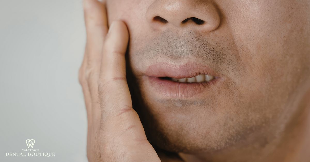 Close-up of jaw discomfort and lower teeth pain caused by tooth infection or abscess